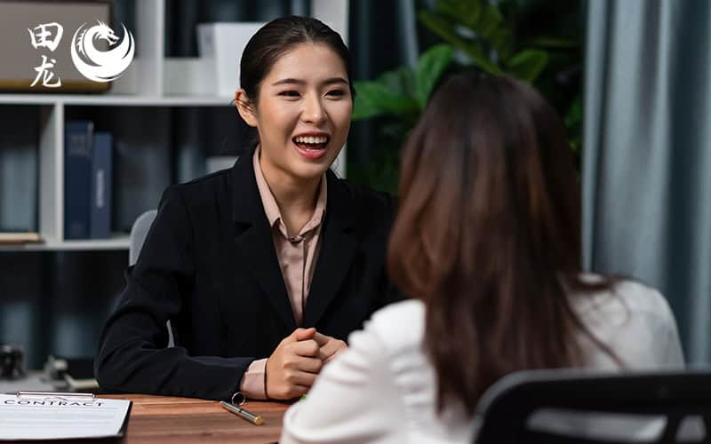 A corporate secretary talking to an employee.