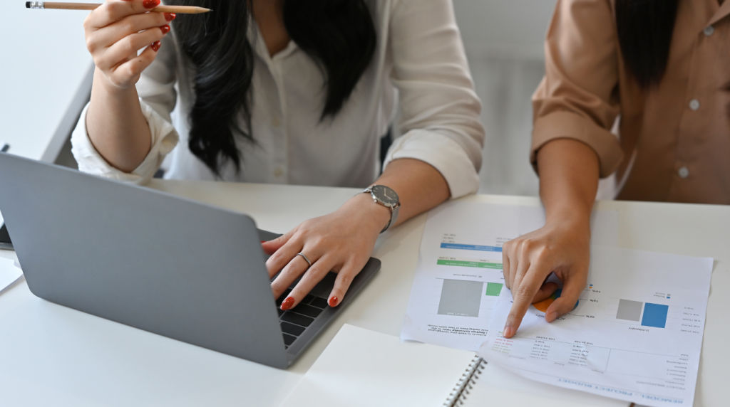 Professional corporate secretary in Singapore reviewing compliance documents and financial reports for an SME.