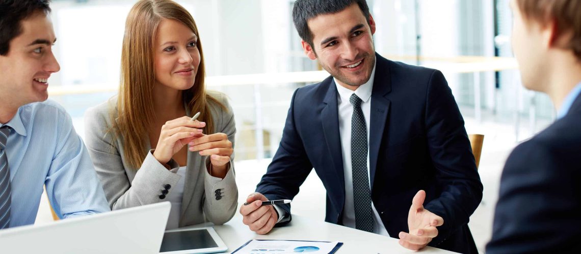 Image of business partners discussing documents and ideas at meeting